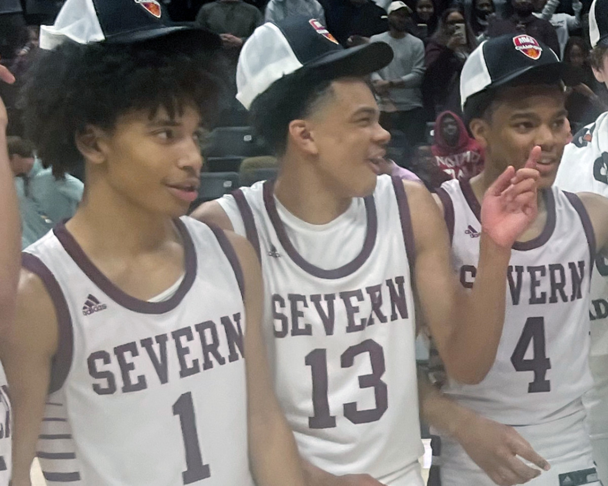 Severn's Corey Dixon (13) shares a laugh with teammates Daniel Growney (left) and Kinston Price after Saturday's MIAA B Conference championship game Saturday at UMBC. Dixon, the son of former Maryland All-American and NBA player Juan Dixon, played a major role this season as a freshman for the Admirals who won their first title in 31 years.